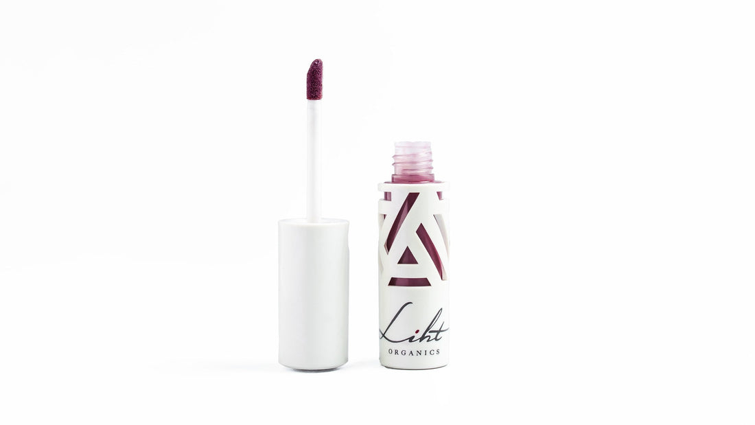 Color-Intense Liquid Lipstick in Sangria, open beside its applicator, on a white background